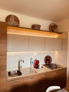 a kitchen with a sink and a stove at Tropisal Apartamento in Santa Maria
