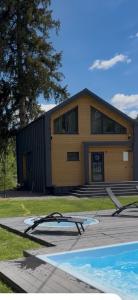 a house with a swimming pool in front of it at Luxury Home in Slavske