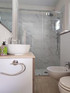 a bathroom with a sink and a toilet and a shower at Camping Jonio in Catania +76 photos