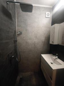 a bathroom with a shower and a sink at Yanevi Apartments in Chernomorets