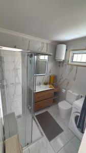 a bathroom with a shower and a toilet and a sink at Nice Studio Apartment with Ocean View in Arguineguín +10 photos
