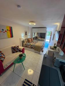 a large living room with a bed and a mirror at Nice Studio Apartment with Ocean View in Arguineguín