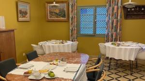 a dining room with two tables and chairs at villazancot in Tangier