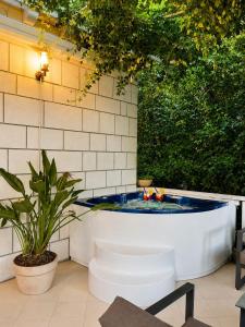 a bath tub sitting in the middle of a patio at Frenchie suite in Lopud