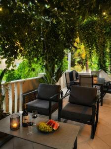 a table with a bowl of fruit on a patio at Frenchie suite in Lopud