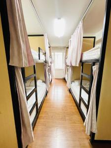 a hallway with three bunk beds in a room at Gobi - Zen in Ulaanbaatar