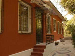 um edifício laranja com um portão ao lado em Casa Vila Brasil - Centro Histórico em Petrópolis