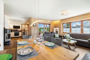 a dining room and living room with a wooden table at Ferienhaus Traum Teufel in Hettingen