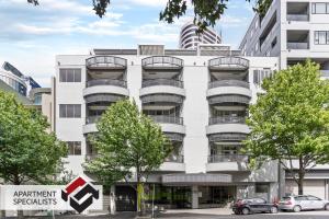 an apartment building with balconies on the side of it at Viaduct Spacious 2 Bedroom Apartment in Auckland