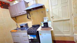 a small kitchen with a stove and a microwave at Apartamento MADERO in Buenos Aires +18 photos