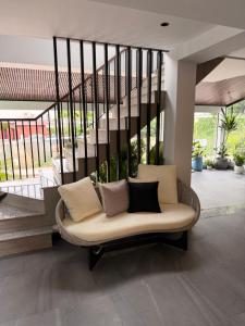 a couch in a living room with a staircase at Sonitori Riverside in Siem Reap