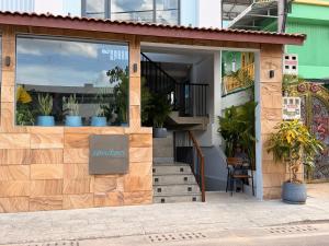 a shop with a window with plants in it at Sonitori Riverside in Siem Reap
