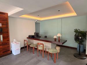 a lobby with a bar with chairs and a counter at Sonitori Riverside in Siem Reap