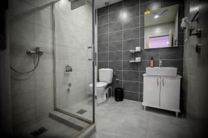 a bathroom with a shower and a toilet and a sink at Hotel Serdar in Mojkovac +54 photos