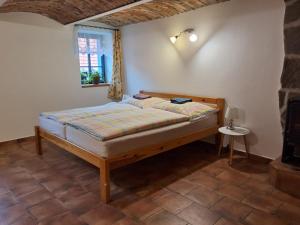 a bedroom with a bed and a window at Apartmán Štrobl in Borovany