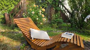a wooden bench with a book sitting on it at Casa La Vie Ferienwohnungen in Altenstadt