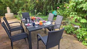 a black table with chairs and drinks on it at Casa La Vie Ferienwohnungen in Altenstadt