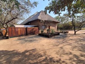 a small brick building with a thatched roof at Bushveld Bliss in Marloth Park