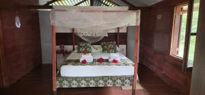 a bed with santa claus on it in a room at Gombela Ecolodge and Farming in São Tomé