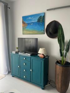 a blue cabinet with a television on top of it at Zacisze na Wspólnej in Bolszewo