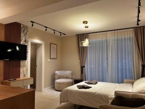 a hotel room with a bed and a chair at Villa Harmonia in Glavati