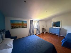 a bedroom with a blue bed and a dresser and a window at Le3sorelle in Monterosi +67 photos