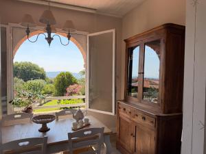 a dining room with a table and a large window at Le3sorelle in Monterosi