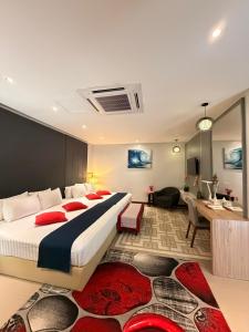 a hotel room with a bed and a living room at Villa Abadi Resort VAR in Pantai Kok +65 photos