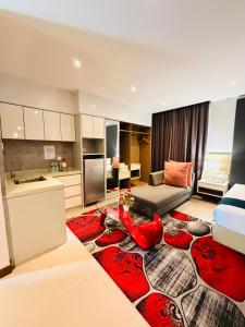 a living room with a bed and a red rug at Villa Abadi Resort VAR in Pantai Kok