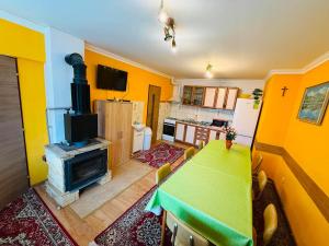a living room with a table and a fireplace at Apart-Bungalovy Gitka in Mlynčeky +18 photos