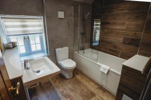 a bathroom with a sink and a toilet and a shower at Mount Pleasant Hotel Self-Catering Cottages in Doncaster +36 photos