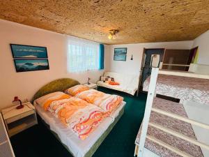a bedroom with a bed and a bunk bed and a ladder at Apart-Bungalovy Gitka in Mlynčeky