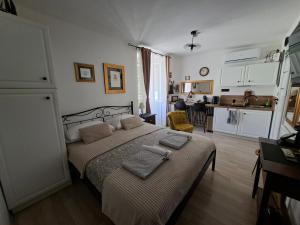 a bedroom with a bed with two towels on it at Apartment Agora in Zadar