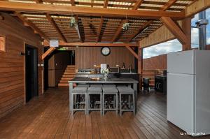 a kitchen with a counter and a refrigerator in a room at Novus Luxury in Yarka