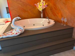 a bath tub sitting on top of a dresser in a bedroom at MATTEO room by 50 shades in Baia Mare +7 photos
