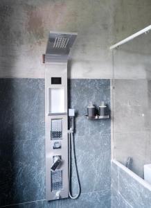 a shower in a bathroom with a sink and a showerilit at Serene Homestay Ella in Ella