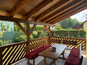 a wooden deck with a table and two chairs at Chata U Druhé pískovny in Roudná