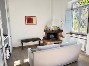 a living room with a white couch and a window at Casa della Consolazione in Todi