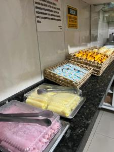 a counter with several trays at Hotel Carrão in São Paulo