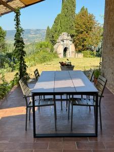 a table and chairs on a patio with a view at Casa della Consolazione in Todi