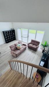 a living room with a couch and a table at Ungura Nord in Mozūriškiai