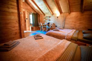a room with two beds and a table in it at Hotel Serdar in Mojkovac