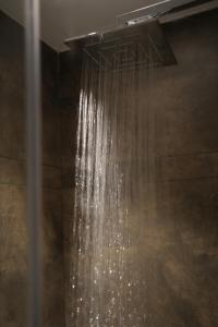 a shower with a stream of water in a bathroom at Jas Grand Homes in Cochin +64 photos