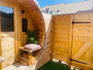 a wooden sauna with a bench in a wooden building at Le Logis de Bamby in Ancelle