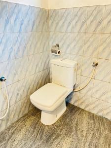 a bathroom with a white toilet in a room at Sana Guest in Weligama +57 photos