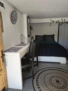 a bedroom with a bed and a desk and a table at Agroturystyka Zdrowo przez sad in Brzezinki +43 photos