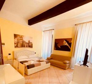a bedroom with a bed and a couch at DIMORA AL SARACENO in Ferrara +88 photos