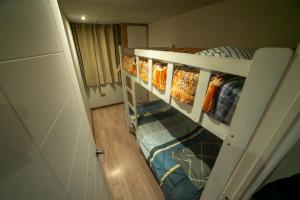 a room with three bunk beds in it at Apartamentos WANCA SUITES para 4, 5 y 6 huéspedes cochera muy cerca al Centro in Huancayo