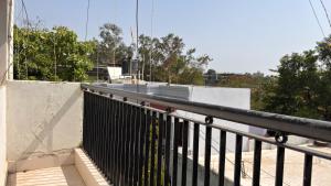 a balcony with a black railing on a building at Preet Residency Homestays in Jabalpur