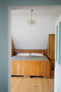 a bed with a wooden frame in a room at Schmidsdorf 67 in Payerbach